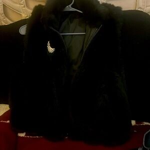 Faux fur vest, black reversible,  zip up,  pockets on both sides.  Dress/casual.